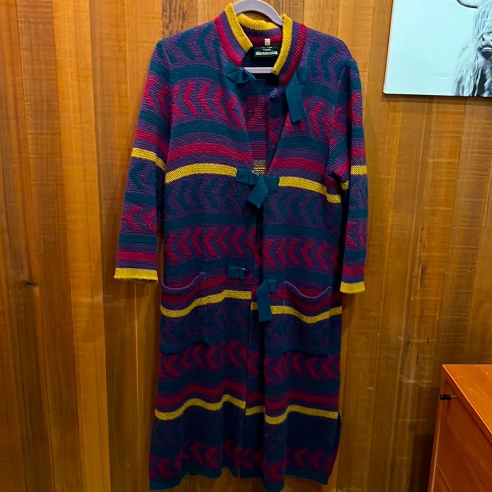 Ankle dusting sweater with great closure details and knit pattern